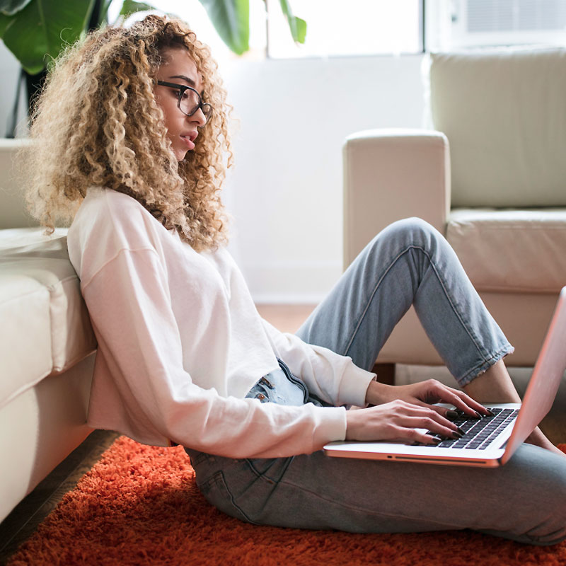 Woman Sitting on Floor Working